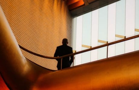 Man alone in Staircase. By Nicole Taylor on Unsplash